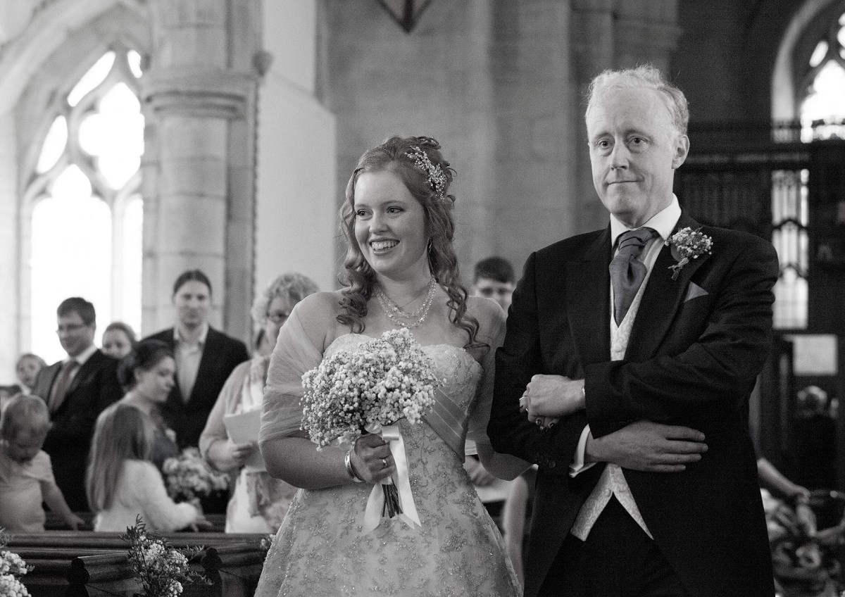 Father and daughter in front of an altar