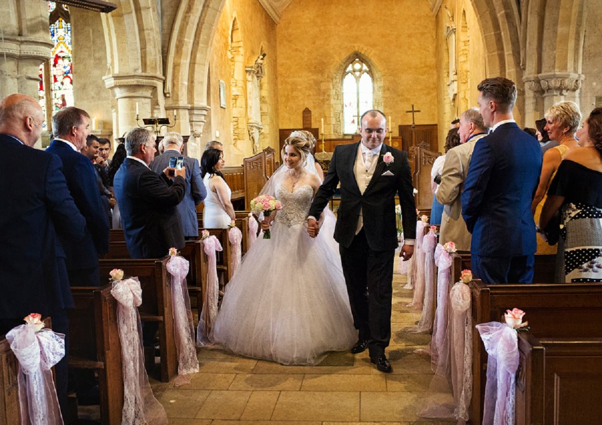 Sara and Adam leaving St Michael and All Angels Church in Wadenhoe